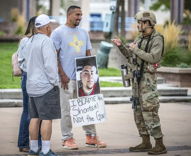 Luiz Otero, centre, holds a sign with his son Elias Otero's image, who was shot and killed a couple years ago in Albuquerque, N.M., as people attend a Second Amendment Protest in response to Gov. Michelle Lujan Grisham's recent public health order suspending the conceal and open carry of guns in and around Albuquerque for 30-days, Tuesday, September 12, 2023, in Albuquerque, N.M. (Photo by Roberto E. Rosales/AP Photo)