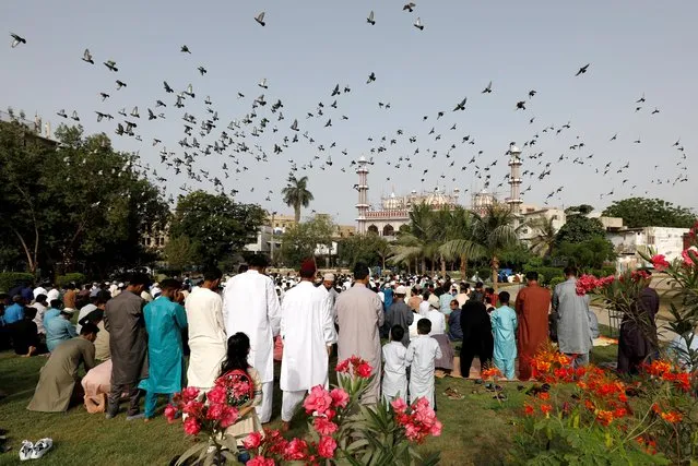 Pakistani Muslims gather to celebrate Eid al-Fitr prayers to mark the end of the holy fasting month of Ramadan in Karachi, Pakistan, May 13, 2021. (Photo by Akhtar Soomro/Reuters)