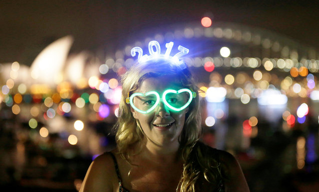 Charlotte Kent from Huddersfield in England wears glowing glasses and a headset for 2017 before watching the New Year's Eve fireworks in Sydney, Australia, December 31, 2016. (Photo by Jason Reed/Reuters)