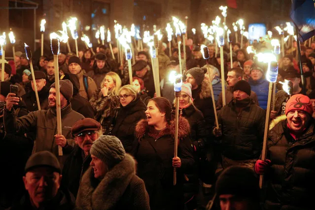 Activists of the Svoboda (Freedom) Ukrainian nationalist party hold torches as they take part in a rally to mark the 108th birth anniversary of Stepan Bandera, one of the founders of the Organization of Ukrainian Nationalists (OUN), in Kiev, Ukraine, January 1, 2017. (Photo by Valentyn Ogirenko/Reuters)