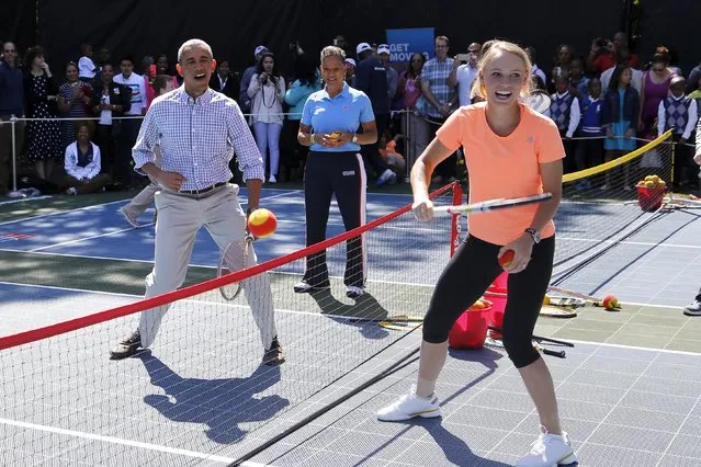 U.S. President Barack Obama plays tennis with tennis player Caroline Wozniacki, one of the activities at the annual Easter Egg Roll at the White House in Washington April 6, 2015. (Photo by Jonathan Ernst/Reuters)