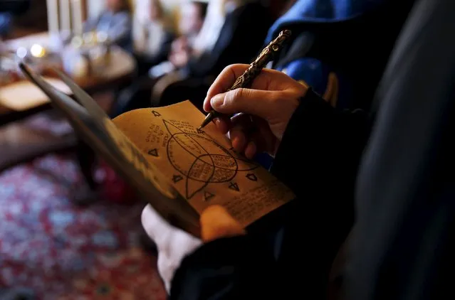 A participant draws on his “secret book” during a workshop before the role play event at Czocha Castle in Sucha, west southern Poland April 9, 2015. (Photo by Kacper Pempel/Reuters)