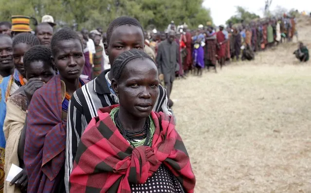 People from Karamojong tribe wait in line to vote in front of a polling station during the presidential elections in a village near town of Kaabong in Karamoja region, Uganda, February 18, 2016. (Photo by Goran Tomasevic/Reuters)