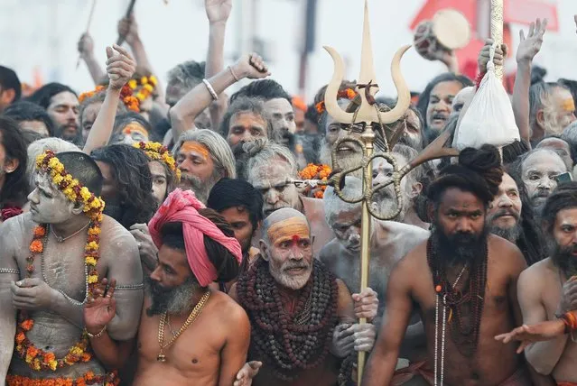 Naga Sadhus or Hindu holy men wait to jump in the waters of Sangam, the confluence of the Ganges, Yamuna and Saraswati rivers, during the second “Shahi Snan” (grand bath) at “Kumbh Mela” or the Pitcher Festival, in Prayagraj, previously known as Allahabad, India, February 4, 2019. (Photo by Adnan Abidi/Reuters)