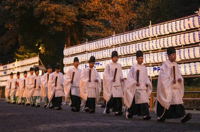 Shinto priests walk past paper lanterns after ending a Shinto ritual in preparation for celebrating the New Year at the inner shrine of Meiji Shrine in Tokyo, Japan, 31 December 2023. It is estimated that about three million people will visit the shrine during the first three days of the New Year 2024 to wish for health and prosperity. (Photo by Kimimasa Mayama/EPA/EFE)