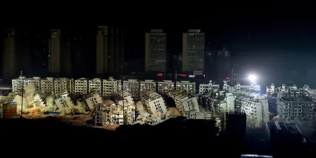 Nineteen buildings are demolished in a controlled explosion at Hankou Binjiang international business district on January 21, 2017 in Wuhan, Hubei Province of China. Nineteen buildings which stood on a construction area of 150,000 square meters were demolished simultaneously in 10 seconds, to make way for the construction of a new business district, including a 707-meter-high skyscraper. (Photo by VCG/VCG via Getty Images)