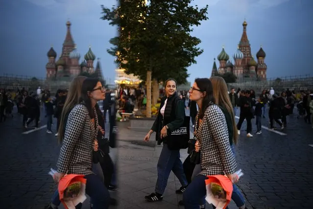 People walk reflecting in a mirror installation after sunset in Red Square in Moscow, Russia, Sunday, September 12, 2021. (Photo by Alexander Zemlianichenko/AP Photo)