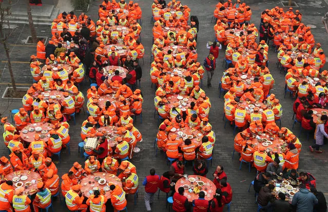 Street cleaners have meal to celebrate the upcoming Spring Festival in Xi'an, Shaaxin province, China January 24, 2017. (Photo by Reuters/Stringer)