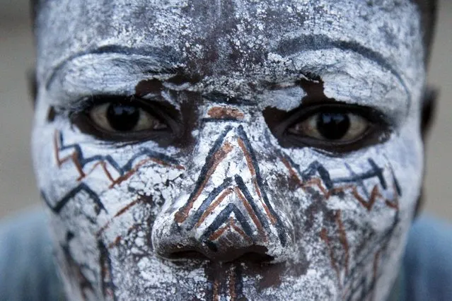 A member of the panther men of Liabo village, an Ivorian traditional dance group, looks on as he prepares to perform at MASA (Market for African Performing Arts) at the culture palace of Abidjan March 10, 2016. (Photo by Luc Gnago/Reuters)