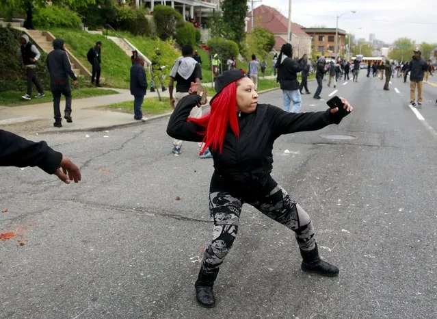 Demonstrators throw rocks at Baltimore police during clashes in Baltimore, Maryland April 27, 2015. Several Baltimore police officers were injured on Monday in violent clashes with young people after the funeral of Freddie Gray, a black man who died in police custody, and local law enforcement warned of a threat by gangs. (Photo by Shannon Stapleton/Reuters)