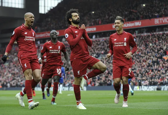 Liverpool's Mohamed Salah, center, celebrates with teammates after scoring his side's second goal during the English Premier League soccer match between Liverpool and Chelsea at Anfield stadium in Liverpool, England, Sunday, April 14, 2019. (Photo by Rui Vieira/AP Photo)