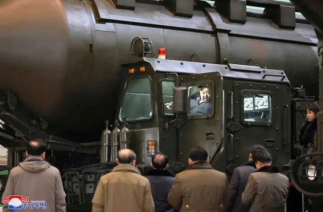 This undated picture released from North Korea's official Korean Central News Agency (KCNA) via KNS on January 5, 2024 shows North Korea's leader Kim Jong Un (top C) boarding a transport launcher as he inspects an important military vehicle production plant with his daughter Ju Ae (far R) at an undisclosed location in North Korea. (Photo by KCNA via KNS/AFP Photo)