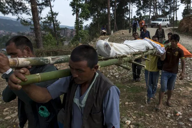 Relatives carry the body of Ramdal Tamang, 74, who died in Tuesday's earthquake to a cremation ground in Sindhupalchowk, Nepal, May 13, 2015. (Photo by Athit Perawongmetha/Reuters)