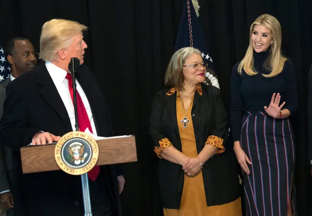 US President Donald J. Trump looks to his daughter Ivanka (R) as she is joined by Alveda King, niece of Martin Luther King Jr., as Trump delivers remarks after touring the Smithsonian National Museum of African American History & Culture in Washington, DC, USA, 21 February 2017. (Photo by Kevin Dietsch/EPA)