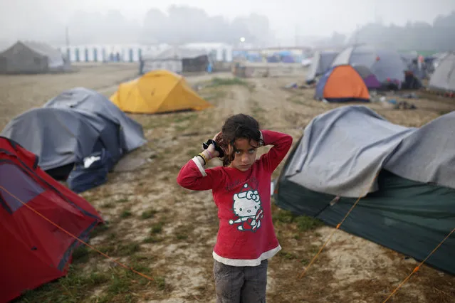 A girl stands between tents at a makeshift camp for migrants and refugees at the Greek-Macedonian border near the village of Idomeni, Greece, April 1, 2016. (Photo by Marko Djurica/Reuters)