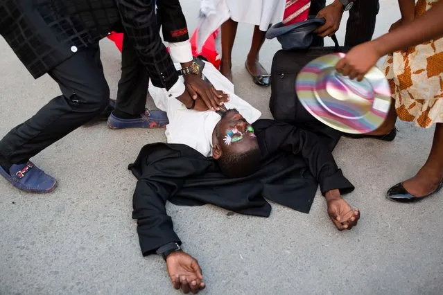 A performer pretends to have suffered a heart attack during a Carnival street parade in Les Cayes, Haiti, Tuesday, February 28, 2017. (Photo by Dieu Nalio Chery/AP Photo)