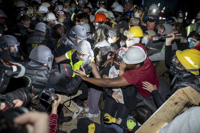 Police advance on pro-Palestinian demonstrators on the UCLA campus Thursday, May 2, 2024, in Los Angeles. (Photo by Ethan Swope/AP Photo)