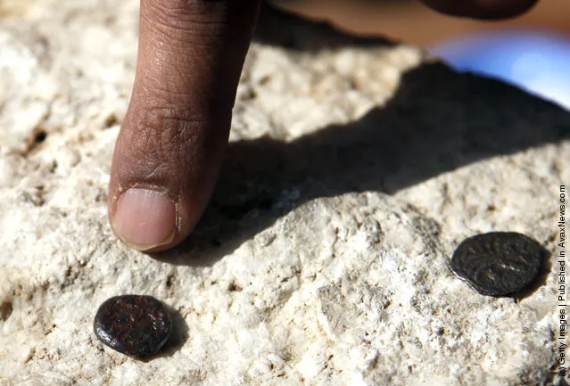 Two ancient bronze coins, which according to Israel Antiquities Authority archaeologists were struck by the Roman procurator of Judea, Valerius Gratus, in the year 17/18 CE and recently were revealed in excavations beneath the Western Wall in Jerusalem's Old City