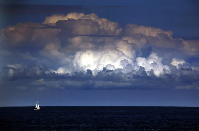 A storm cloud can be seen behind a yacht as it sails off the coast of Sydney March 31, 2014. The Bureau of Meteorology last week forecast “warmer and drier than usual” weather extending well into winter for Sydney and most of south-eastern Australia over the next three months. (Photo by David Gray/Reuters)