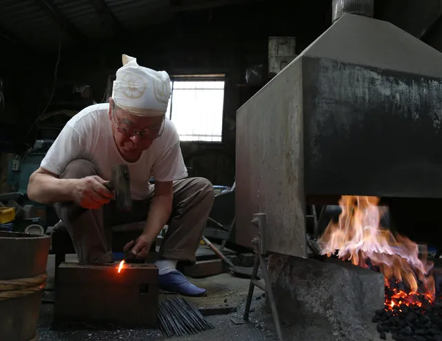 A master Myouchin Munemichi, 72, as he produces Hbashi iron bells made of iron at Myochin Honpo shop on April 25, 2014 in Himeji, Japan. Myochin family's iron business, started in the Heian period (794-1185) of Japan as an armor and helmet maker, shifted as the needs of people changed in the course of history. (Photo by Buddhika Weerasinghe/Getty Images)