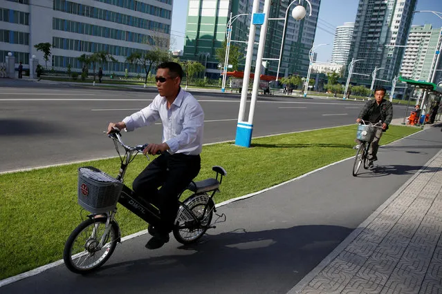 A man rides an electric bicycle at newly built Mirae Scientists Street in central Pyongyang, North Korea May 7, 2016. (Photo by Damir Sagolj/Reuters)