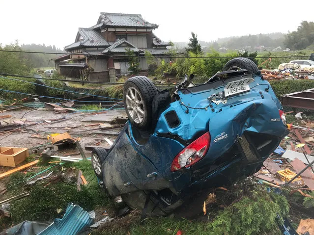 A car is overturned after a tornado hit Chiba Prefecture near Tokyo, Japan, on October 12, 2019. A tornado formed during the course of the Typhoon Hagibis hit Chiba Prefecture near Tokyo on Saturday, injuring five people, according to Chiba's prefectural government. The tornado destroyed a house and damaged at least nine others. A man was found dead in an overturned car, though it was not immediately known if the tornado caused his vehicle to roll over, local officials said. (Photo by Deng Min/Xinhua News Agency)
