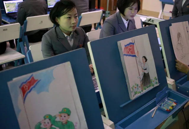 In this Tuesday, January 29, 2019, photo, students make story boards depicting North Korean flags being raised during a multi media production class at Pyongyang Teachers' University, a teacher training college, in Pyongyang, North Korea. North Korea is stepping up a new loyalty campaign that began last month with the introduction of a song in praise of the nation's flag. (Photo by Dita Alangkara/AP Photo)