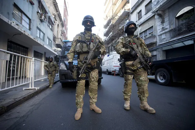 Police special forces provide security for the ceremony marking the 21st anniversary of the 1994 terror attack of the AMIA Jewish community center in Buenos Aires, Argentina, Friday, July 17, 2015. The bombing of the Argentine-Israeli Mutual Association in downtown Buenos Aires killed 85 people and remains unsolved. (Photo by Victor R. Caivano/AP Photo)