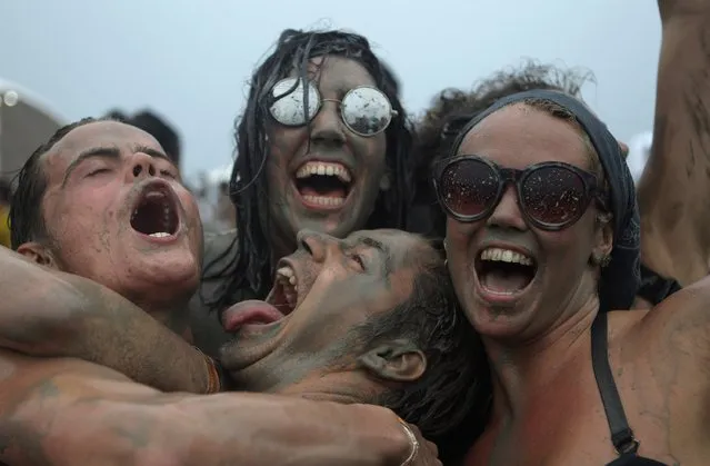 Festival-goers enjoy the mud during the annual Boryeong Mud Festival at Daecheon Beach on July 18, 2015 in Boryeong, South Korea. (Photo by Chung Sung-Jun/Getty Images)