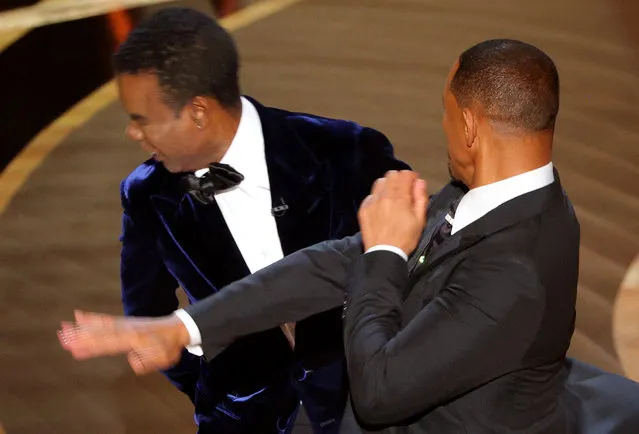Will Smith (R) hits Chris Rock as Rock spoke on stage during the 94th Academy Awards in Hollywood, Los Angeles, California, U.S., March 27, 2022. (Photo by Brian Snyder/Reuters)