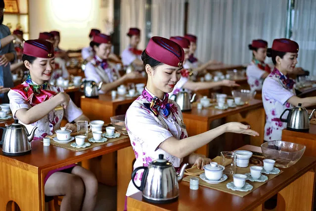 Train attendants attend an etiquette trainning as the May Day holiday approaches on April 26, 2022 in Chongqing, China. (Photo by Su Zhigang/VCG via Getty Images)