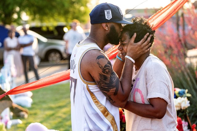 Robert Jackson, 35, consoles Cheryl Jackson at a makeshift memorial on Monday, May 8, 2023 outside the Allen Premium Outlets where a gunman killed 8 and wounded 7 before being killed by police Saturday evening in Allen, Texas. (Jeffrey McWhorter for The Washington Post)