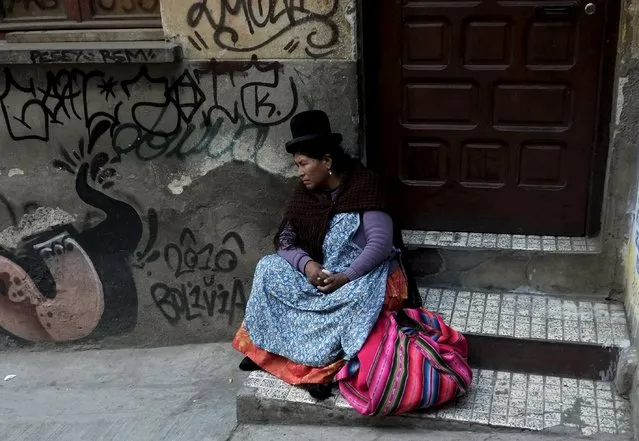An Aymara woman rests at the witch doctor's street in La Paz, Bolivia July 31, 2015. (Photo by David Mercado/Reuters)