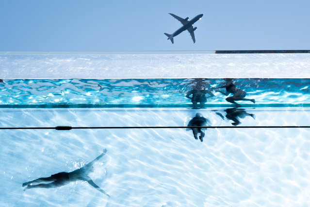 Swimmers in the Sky Pool, a transparent swimming pool suspended 35 meters above ground between two apartment buildings, during hot weather in Nine Elms, central London on Monday, August 12, 2024. (Photo by James Manning/PA Images via Getty Images)