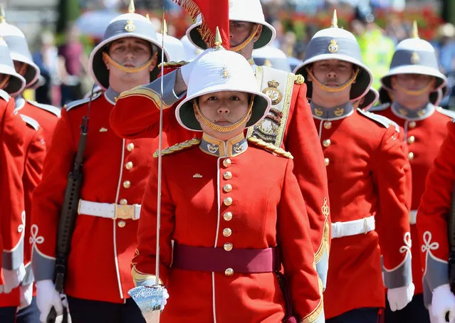 Captain Megan Couto (C) of the 2nd Battalion, Princess Patricia's Canadian Light Infantry (PPCLI) leads her battalion to makes history as the first woman to command the Queen's Guard at Buckingham Palace in central London on June 26, 2017. (Photo by John Stillwell/AFP Photo)