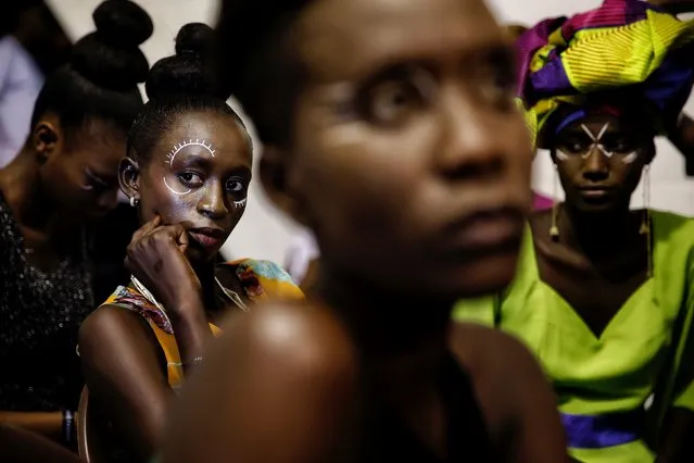 Models sit backstage during Dakar Fashion Week in the Senegalese capital, Friday June 30, 2017. (Photo by Finbarr O'Reilly/AP Photo)
