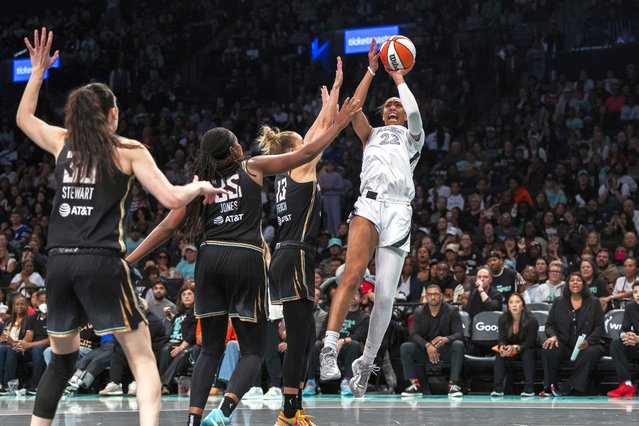 Las Vegas Aces center A'ja Wilson (22) shoots over New York Liberty forward Leonie Fiebich (13) as forward Breanna Stewart (30) and forward Jonquel Jones (35) defend during the second half of a WNBA basketball second-round playoff game, Sunday, September 29, 2024, in New York. (Photo by Corey Sipkin/AP Photo)