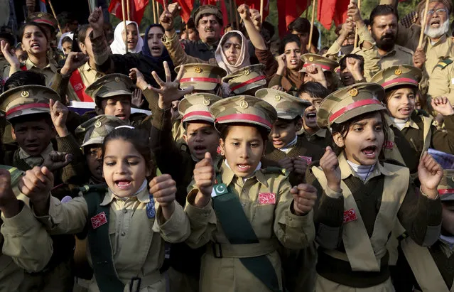 Children wear army uniform take part in a demonstration called by a social movement “Khaksar Tahreek” against the recent U.S. attack in Iraq that killed Iranian Gen. Qassem Soleimani, near U.S. consulate in Lahore, Pakistan, Friday, January 10, 2020. (Photo by K.M. Chaudary/AP Photo)
