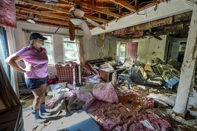 Cindy White looks over the devastation inside her home caused by Hurricane Helene, Tuesday, October 1, 2024 in Morganton, N.C. The adjacent Catawba River flooded due to the torrential rains destroying the seven of family's nine homes on the property. (Photo by Kathy Kmonicek/AP Photo)