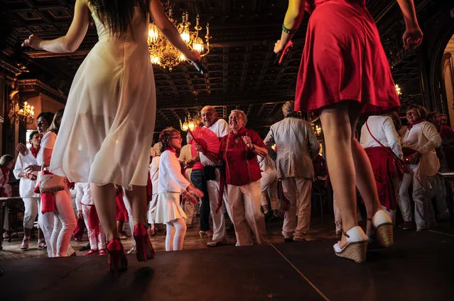 People dance at the San Fermin festival, in Pamplona, Spain, on Jule 11, 2014. Revelers from around the world arrive to Pamplona every year to take part in some of the eight days of the running of the bulls. (Photo by Alvaro Barrientos/Associated Press)