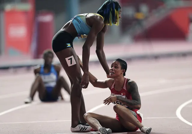 Salwa Eid Naser, of Bahrain, right, reacts after winning the gold medal while being congratulated by greeted by silver medalist Shaunae Miller-Uibo, of Bahamas, after the women's 400 meter final and is at the World Athletics Championships in Doha, Qatar, Thursday, October 3, 2019. (Photo by Nariman El-Mofty/AP Photo)