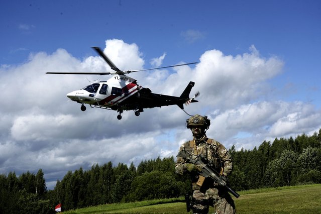 Latvian Border Guard helicopter takes off near Latvia-Russia border near Lidumnieki, Latvia on August 8, 2023. (Photo by Ints Kalnins/Reuters)