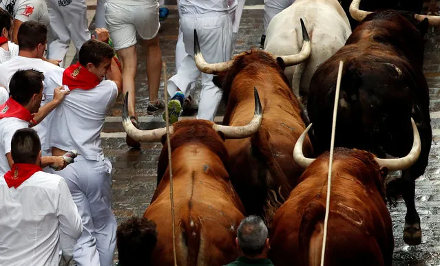 A runner avoids the horn of a Pedraza de Yeltes bull during the fourth running of the bulls at the San Fermin festival in Pamplona, northern Spain, July 10, 2016. (Photo by Susana Vera/Reuters)