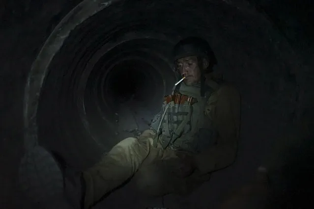In this photo taken on Sunday, August 23, 2015, an Ukrainian government soldier rests in a shelter at his positions near Avdiivka, outside Donetsk, eastern Ukraine. Ukraine's military said Monday August 24, 2015  that the rebels violated a cease-fire 82 times overnight in the eastern part of the country, in some cases with large-caliber weapons that should have been withdrawn in line with a truce signed in February. (Photo by Max Black/AP Photo)