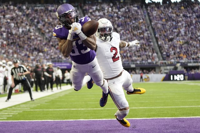 Minnesota Vikings running back Aaron Jones (33) reaches for an incomplete pass ahead of Arizona Cardinals linebacker Mack Wilson Sr. (2) during the second half of an NFL football game Sunday, December 1, 2024, in Minneapolis. (Photo by Abbie Parr/AP Photo)