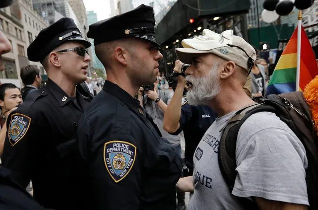 A protester (R) is confronted by New York City police during a protest march from Grand Central Station to Times Square in New York, New York, USA, 18 September 2017. US President Donald J. Trump will be meeting with heads of state during the United Nations (UN) General Assembly in New York on 19 September. (Photo by Peter Foley/EPA/EFE)