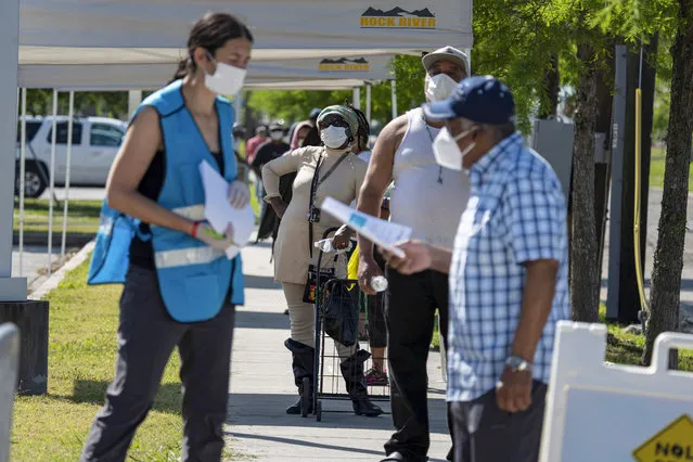 People line up for walk-up coronavirus disease (COVID-19) testing which is part of a new mobile metro-wide campaign, at Xavier University of Louisiana in New Orleans, Louisiana, U.S., April 21, 2020. (Photo by Kathleen Flynn/Reuters)