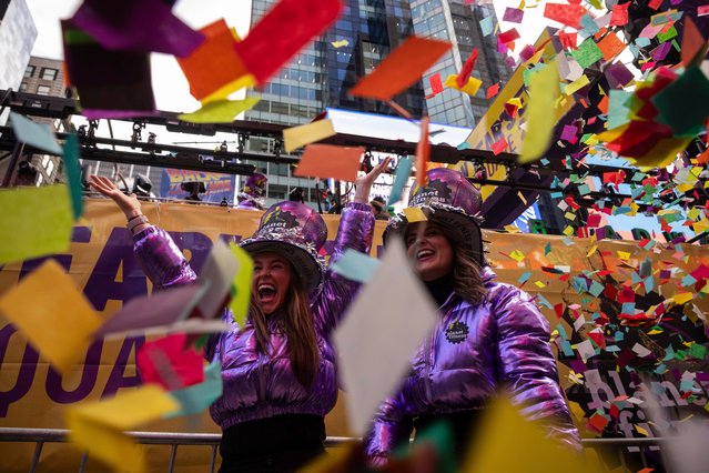 People throw confetti during a confetti test ahead of New Year's Eve in Times Square, Friday, December 29, 2023, in New York. (Photo by Yuki Iwamura/AP Photo)