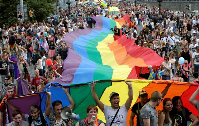 Participants hold a giant rainbow flag during the Prague Pride Parade where thousands marched through the city centre in support of gay rights, in Czech Republic, August 13, 2016. (Photo by David W. Cerny/Reuters)