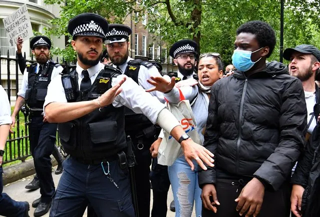 Protesters react next to police officers in London during a “Black Lives Matter” protest following the death of George Floyd who died in police custody in Minneapolis, London, Britain, June 3, 2020. (Photo by Dylan Martinez/Reuters)